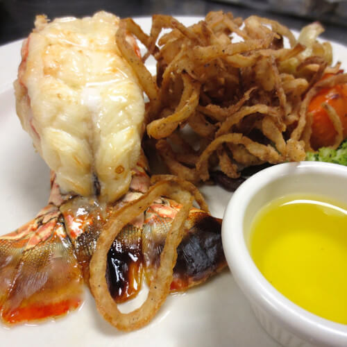 lobster tail dinner with a vegetable medley